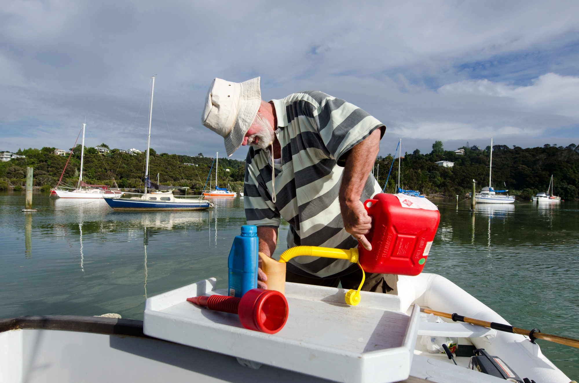 Man pouring fuel in boat