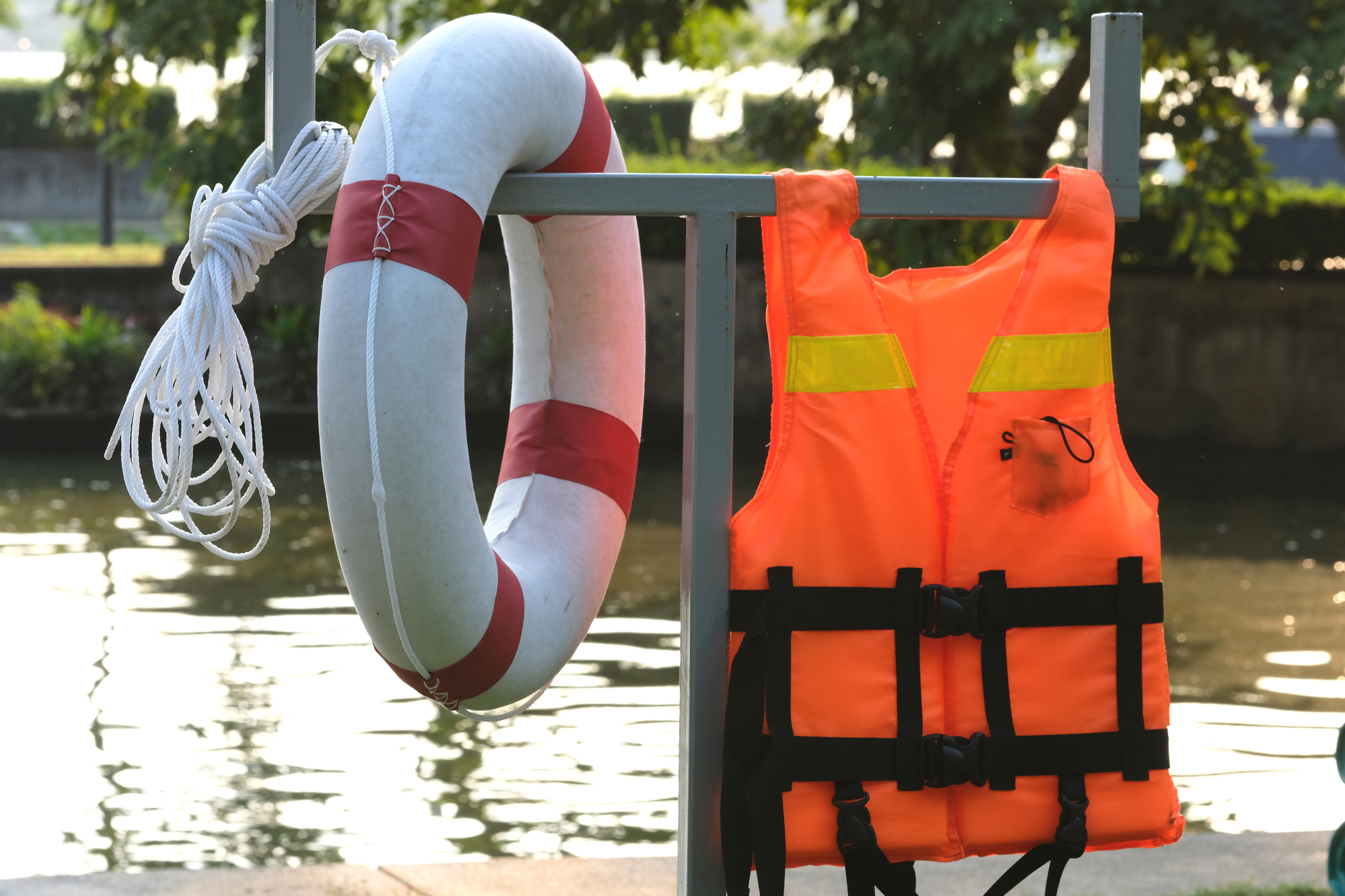 Safety buoy and lifeguard equipment on the riverbank