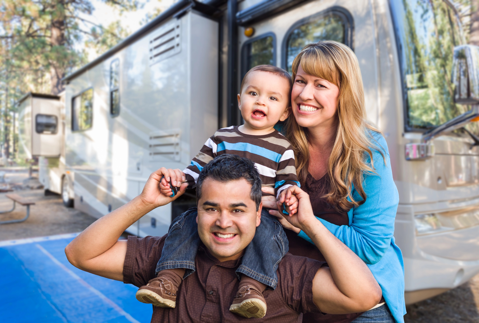 Happy Young Mixed Race Family In Front of Their Beautiful RV